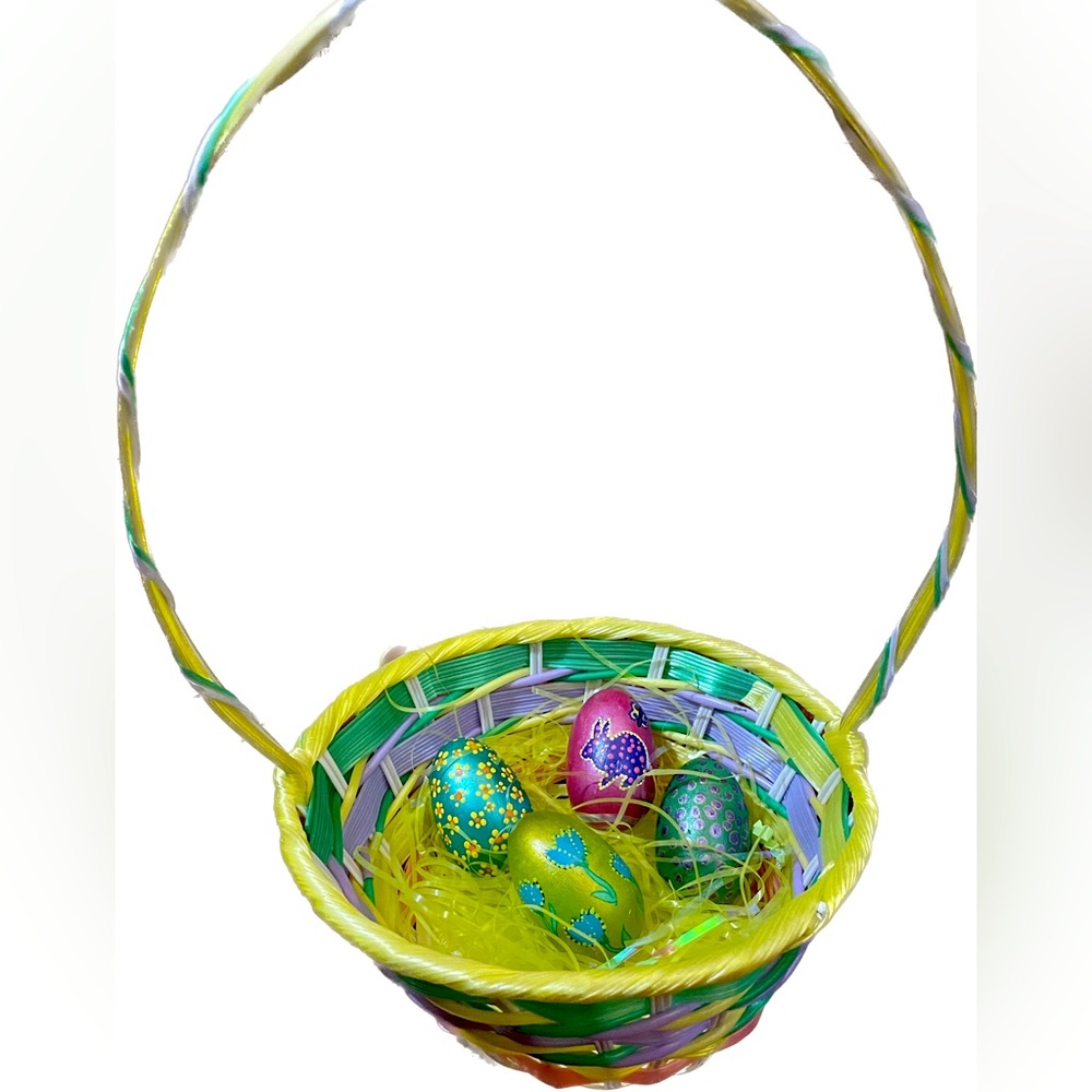 Hand crafted painted four rock Easter eggs in plastic woven basket floral bunny